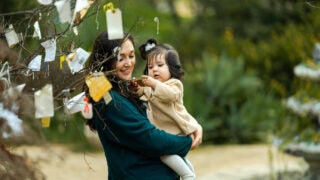 Cynthia Diana Villarreal, who studies college access and faculty hiring issues, holds her daughter, Diana.