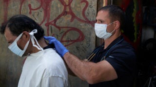 Street Medicine team member helping homeless man