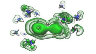 Solvated electrons (green) in the gaps between ammonia molecules (blue and white) begin to coalesce into a pair as a solution moves toward becoming metallic. (Image/Ondřej Maršálek)