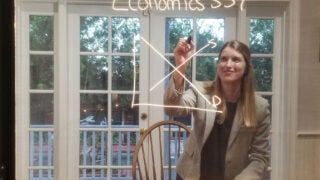 Emily Nix built her own lightboard to bring her economics lectures to life while teaching online this fall. (Photo/Courtesy of Emily Nix)