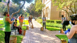 While taking appropriate precautions, Julie Hopper and her students gathered on the University Park Campus to research the impact of pesticides on biodiversity. (Photo/Courtesy of Julie Hopper)