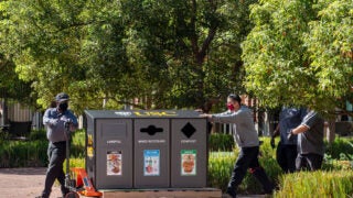 USC workers install no-touch recycling stations at USC Village. (USC Photo/Gus Ruelas)