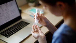 Woman applying hand sanitizer