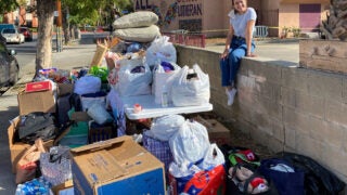 student providing water for unhoused individuals