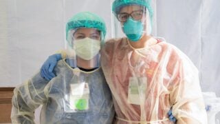 Keck Medicine of USC nurses Sayuri Silva, left, and Claire Hoffman wear personal protective equipment during the pandemic.