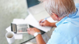 elderly male filling out paperwork