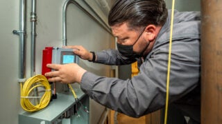 Juan Blake attaches water meter sensor