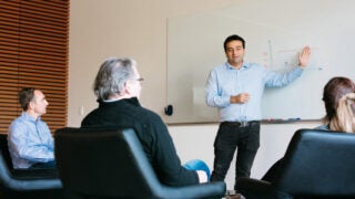 man presenting to group of adults