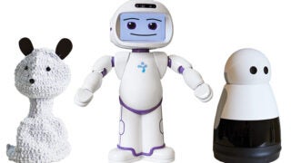 Three different types of toy robots side by side, on the left one shaped like a teddy bear, in the middle a humanoid toy, and on the right one resembling a can.