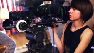 woman filming with video camera