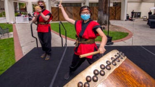 Esther Hsu hits a drum