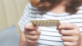 woman holding birth control