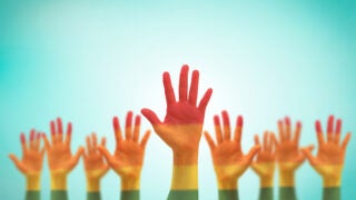 rainbow colored hands raised