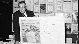 Milo Sweet holding newspaper article