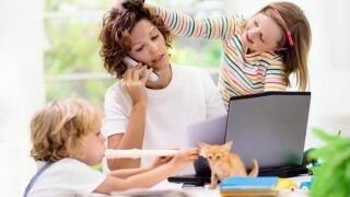 mother on the phone while children are interrupting