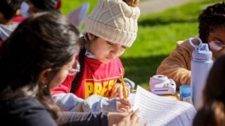 children writing outside