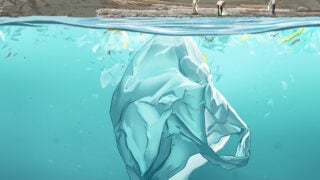 Individuals picking up trash near the ocean while trash floats under the surface of the water
