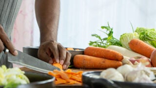 person cutting vegetables