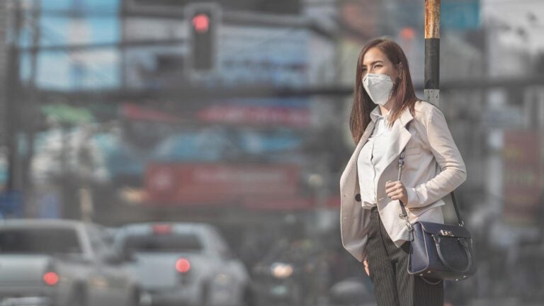 woman wearing corporate clothes with a face covering