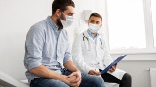 male doctor and patient wearing face coverings