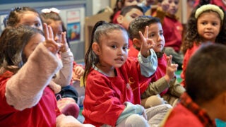 Children holding up the 'Fight On' sign