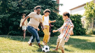 family playing soccer outside