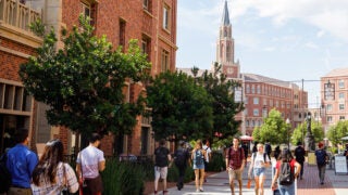 students walking in USC Village