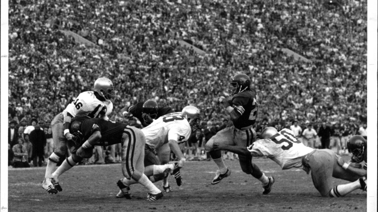 Black and white photo of USC football players at the LA Coliseum