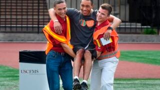 Two students carrying a third student during earthquake drill