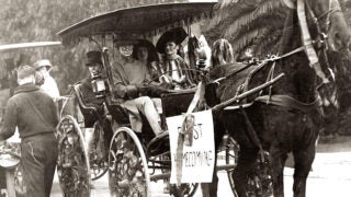 People in a horse carriage at USC's first homecoming game at the Los Angeles Coliseum