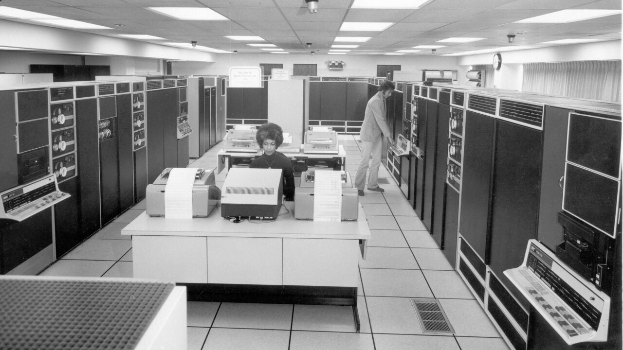 Black and white photo of mainframe computers in a room