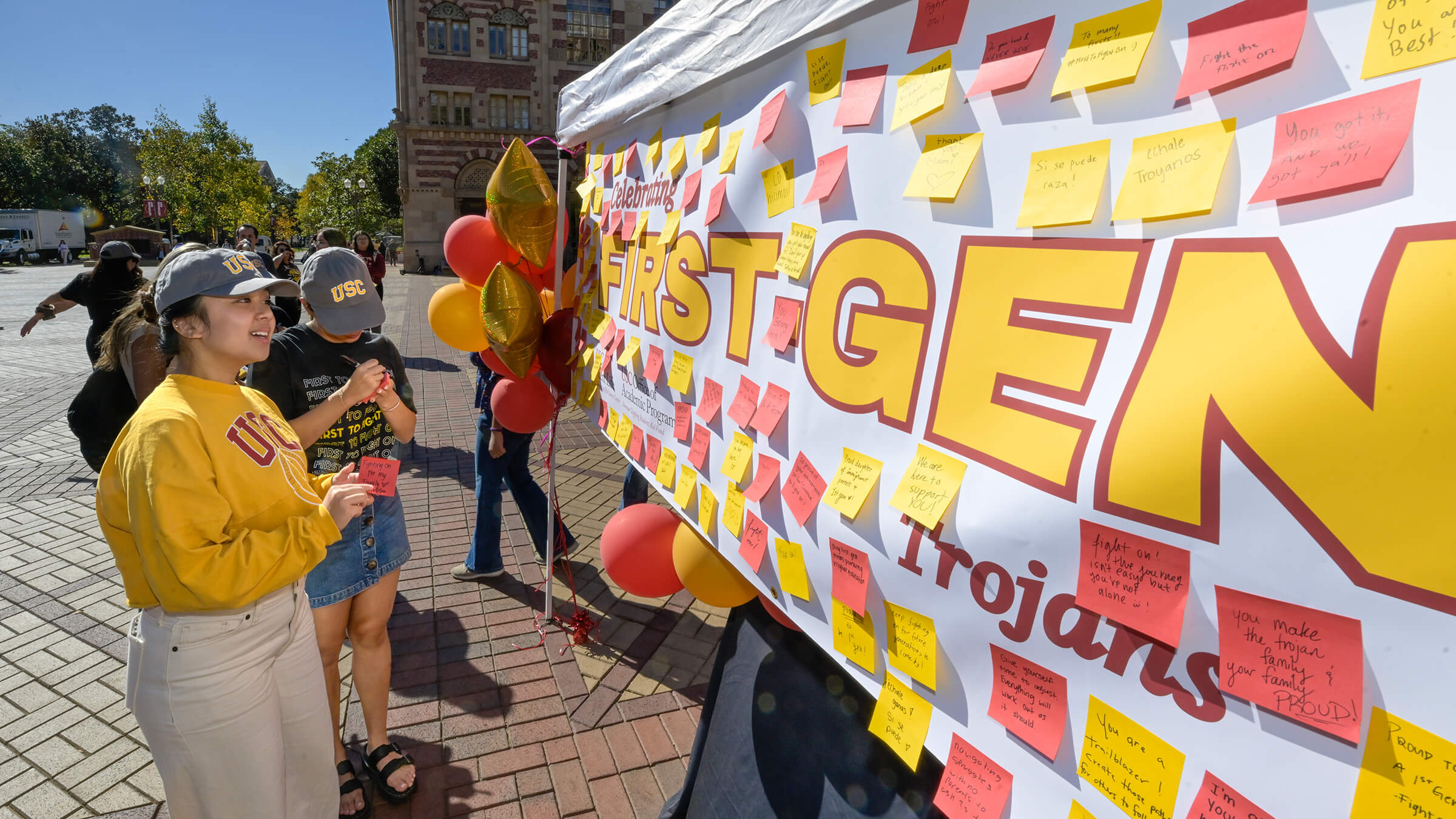 USC students write on sticky notes to be places on a banner during National First-Generation College Celebration Day.