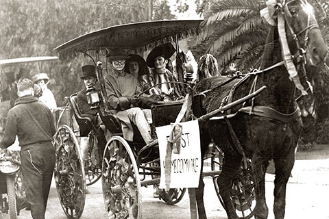 Image of people in a horse carriage at USC's first homecoming game at the Los Angeles Coliseum