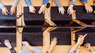 Top view of female students programming together