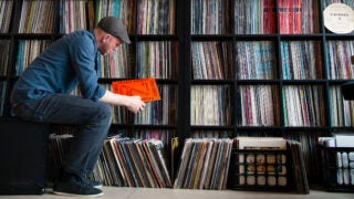 Man looking at vinyl record albums