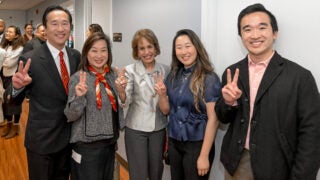 USC President Carol Folt takes a photograph with the Yip Family during the graduate school centennial celebration, April 4, 2024.