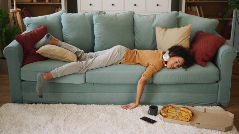 Junk food diet: Teen sleeping after eating pizza