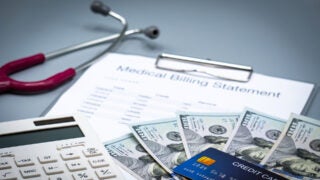 Photo illustration: Medical bill, cash and credit card