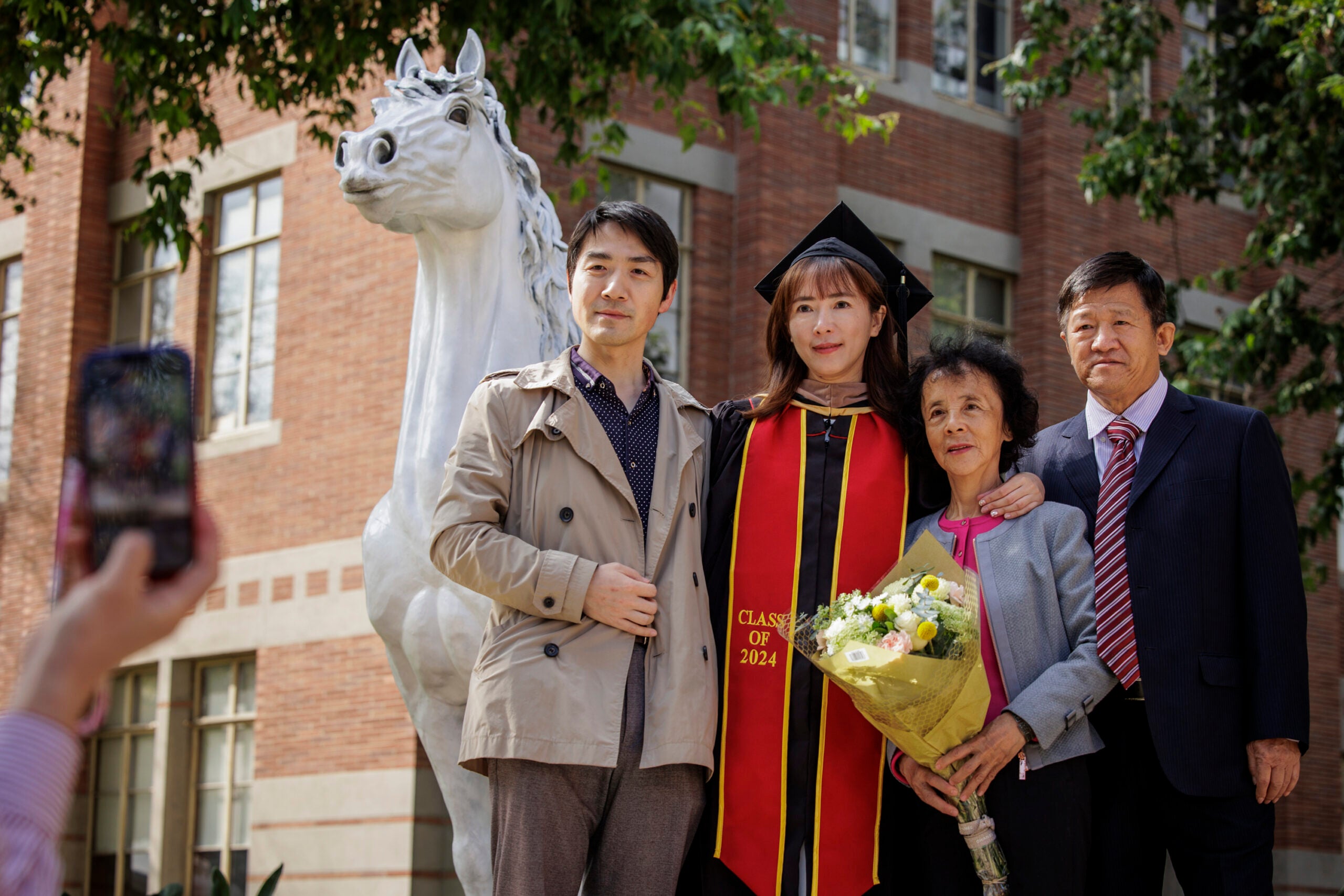 USC 2024 commencement: family and graduate with Traveler