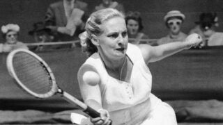 Caption/Credit Info: Darlene Hard hits a forehand to Zsuzsa Kormoczy during a quarterfinal on June 28, 1955 at Wimbledon tennis championships in London. Hard, an aggressive serve-and-volley player who won three major singles titles as well as 18 major doubles titles in a Hall of Fame tennis career, died Thursday, Dec. 2, 2021, after a brief illness. She was 85. (AP Photo, File)