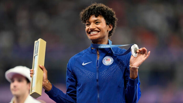 A woman holding a medal