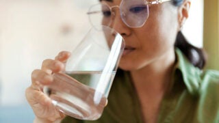 Person drinking a glass of water