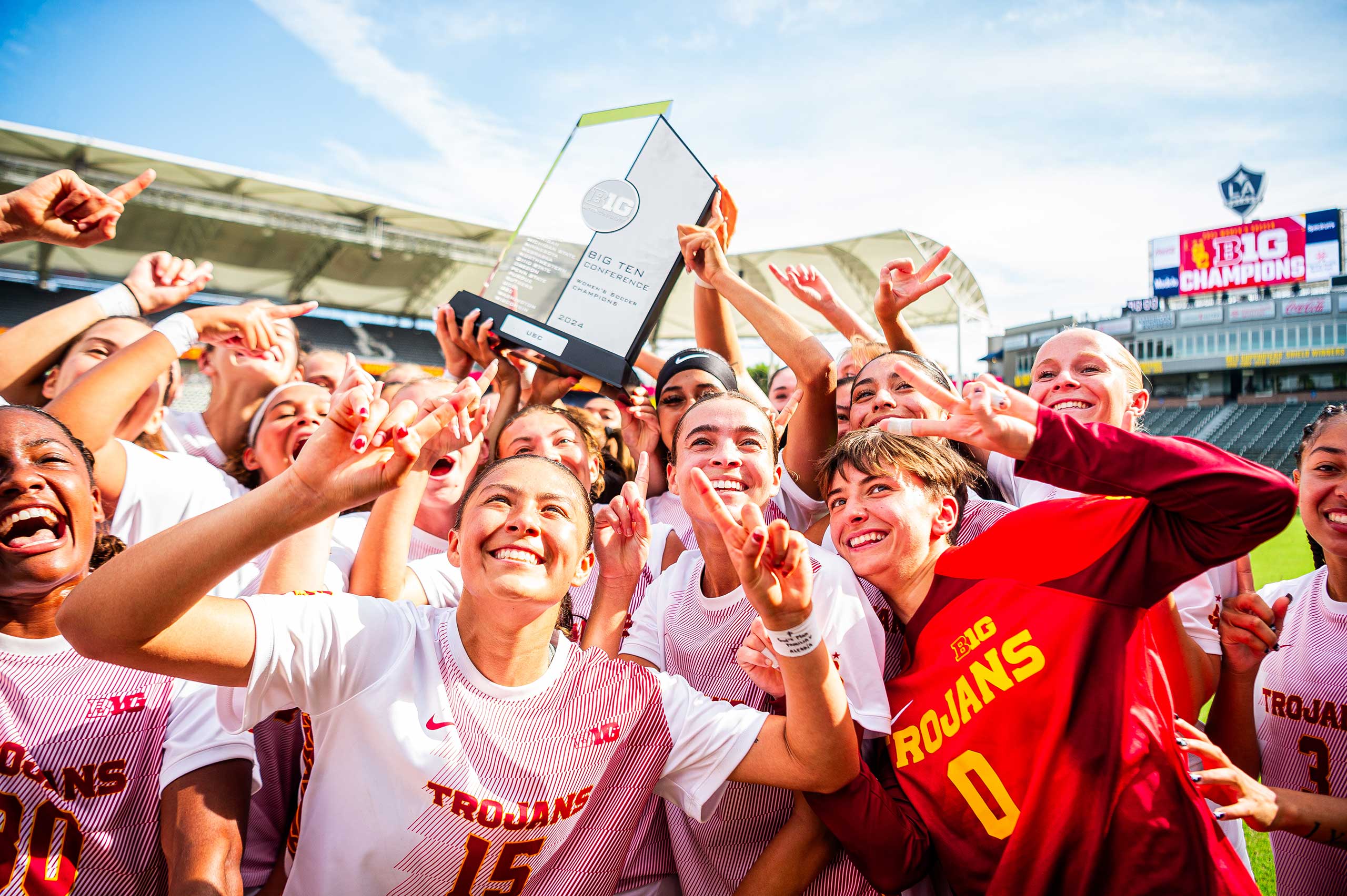 USC Women’s soccer team holding the Big Ten Conference title trophy