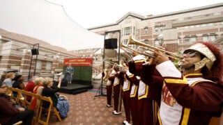 The USC Trojan Marching Band celebrates Leavey Library’s 30th birthday in style on Wednesday as Melissa Just, dean of USC Libraries, looks on. (USC Photo/Steve Cohn)