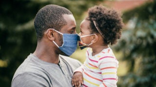 Adult and child wearing masks