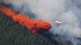 Plane drops flame retardant