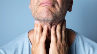 Person holding their neck