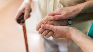 Hands of younger person helping an older person