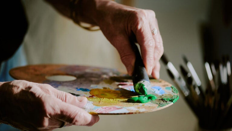 Older artist with paint palette