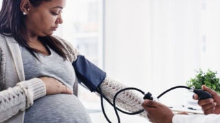 Pregnant woman getting blood pressure checked